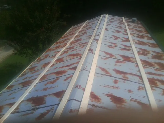 Rusted metal roof panels with new wood purlins before replacement — Storm Damage Roof Repair in Bannock by Roofing Brothers