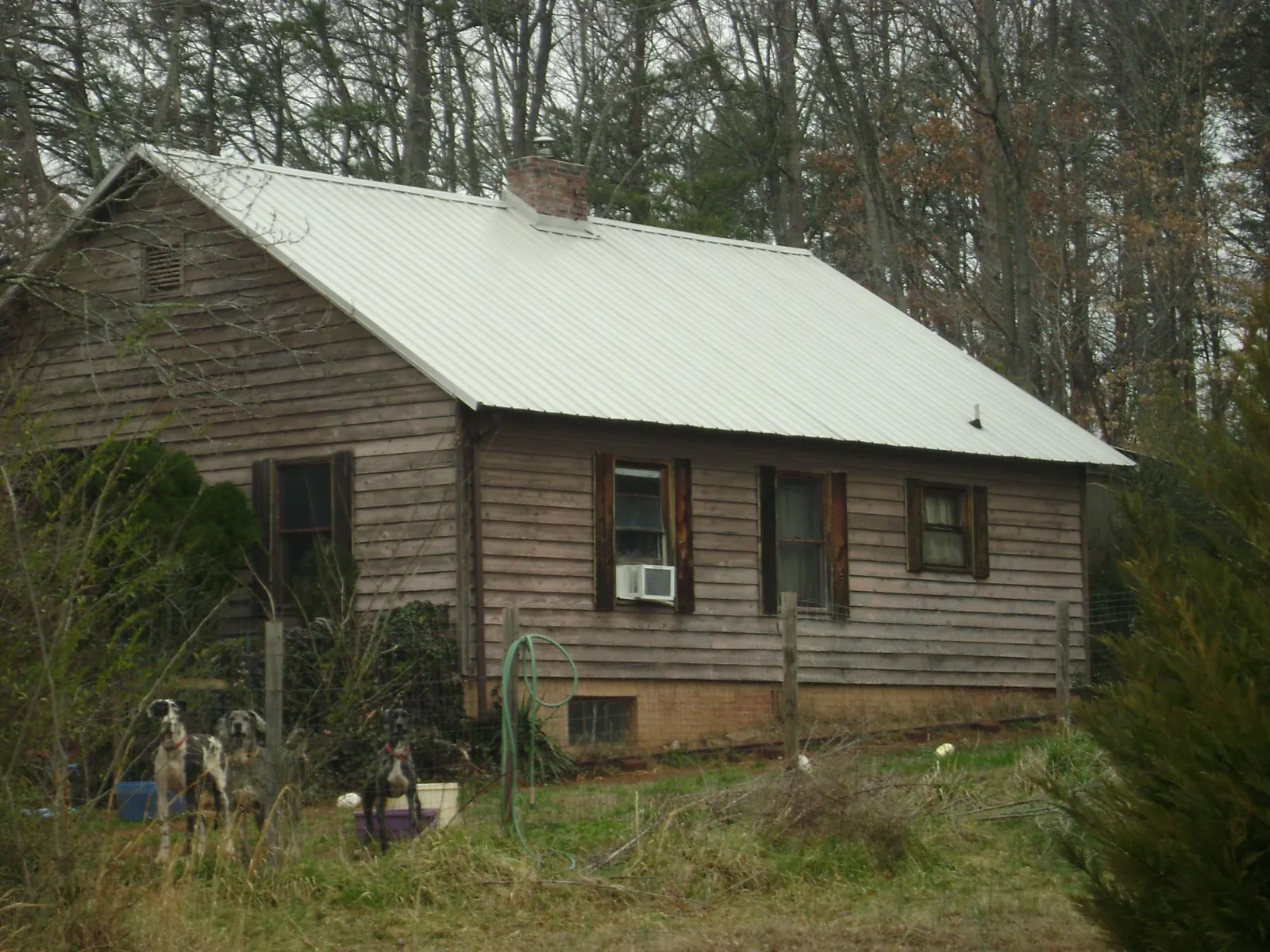 White metal roof on an old wood sided farmhouse, from a Metal Roof Installation job in Bannock